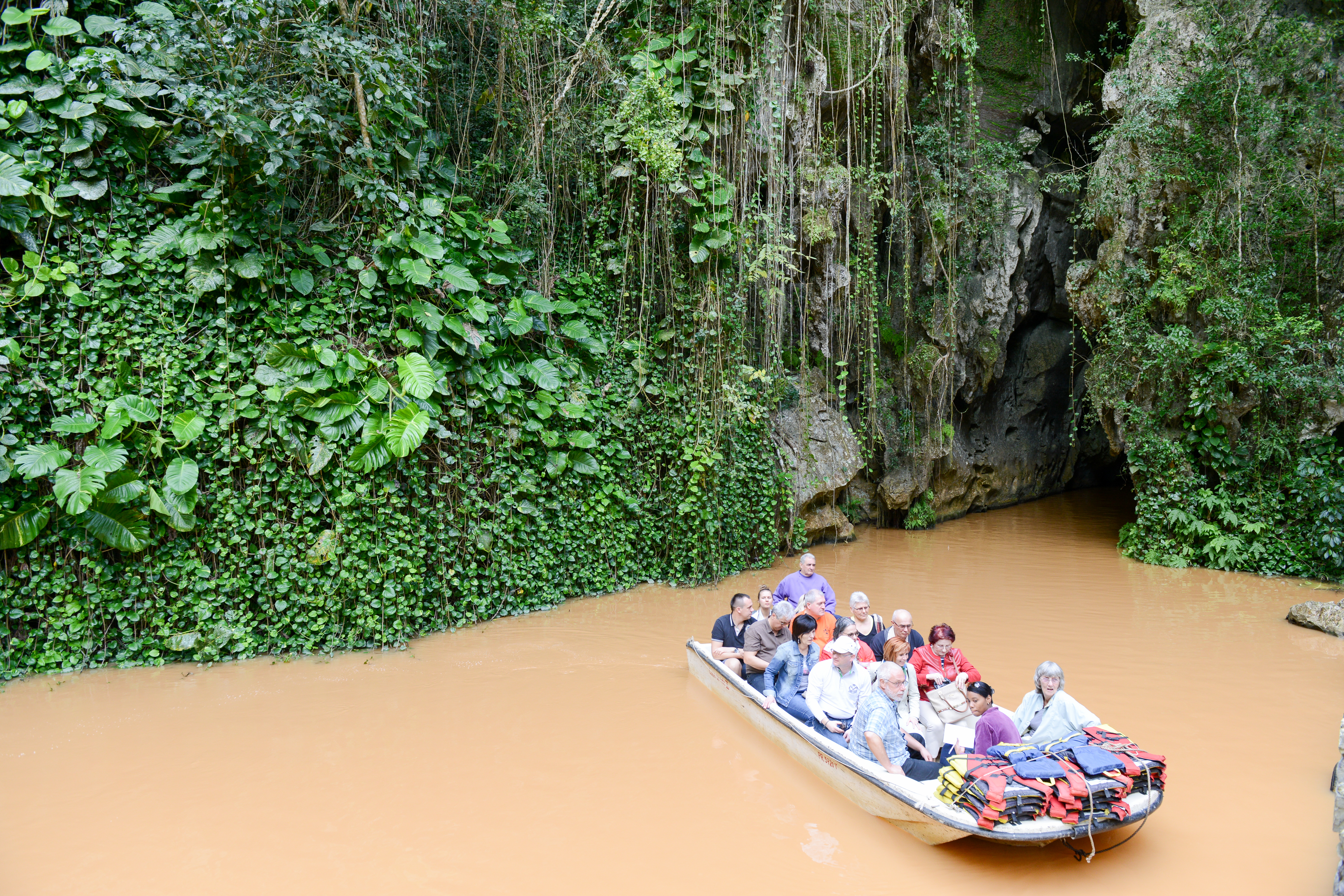 shutterstock_395991841 tourists on boat that has crossed the cave of Indio at Vinales.jpg