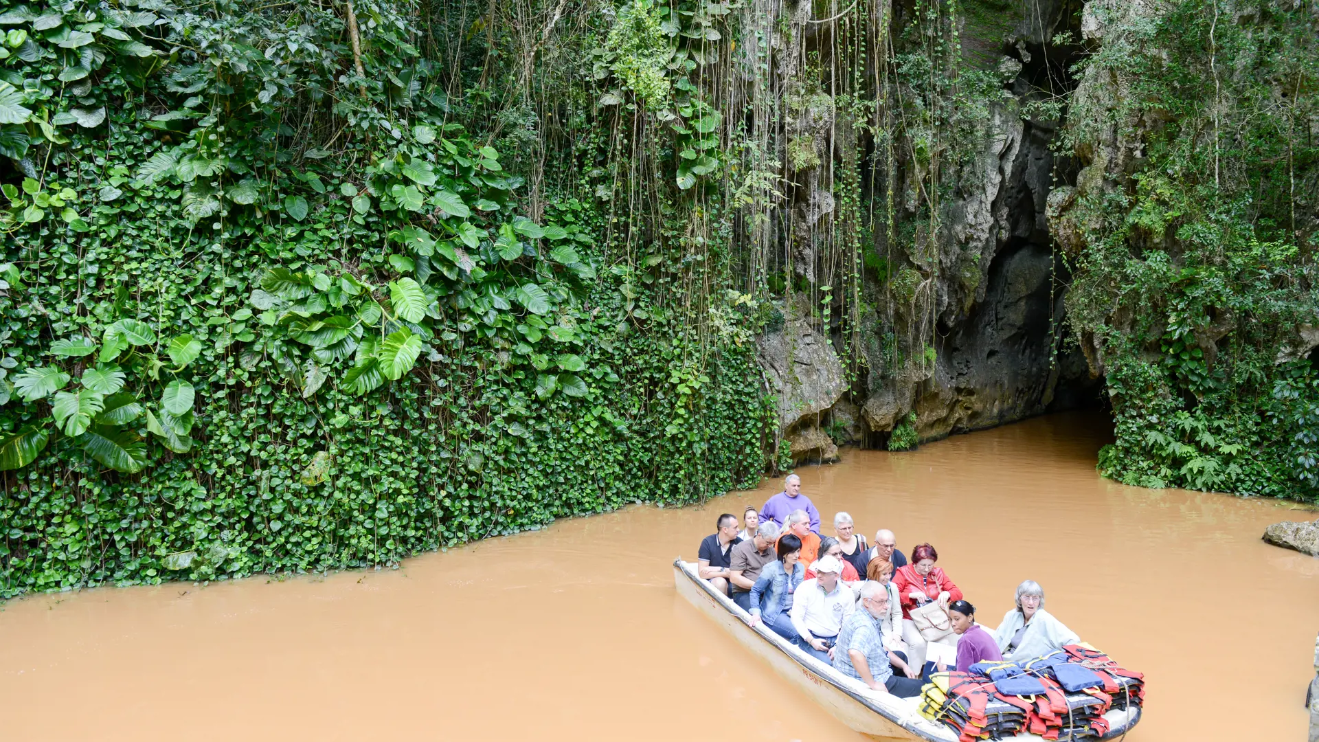 shutterstock_395991841 tourists on boat that has crossed the cave of Indio at Vinales.jpg