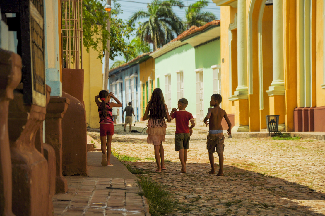 TRINIDAD, CUBA - MAY 26, 2013  kids walking on the street in UNESCO protected city of Trinidad, Cuba..jpg
