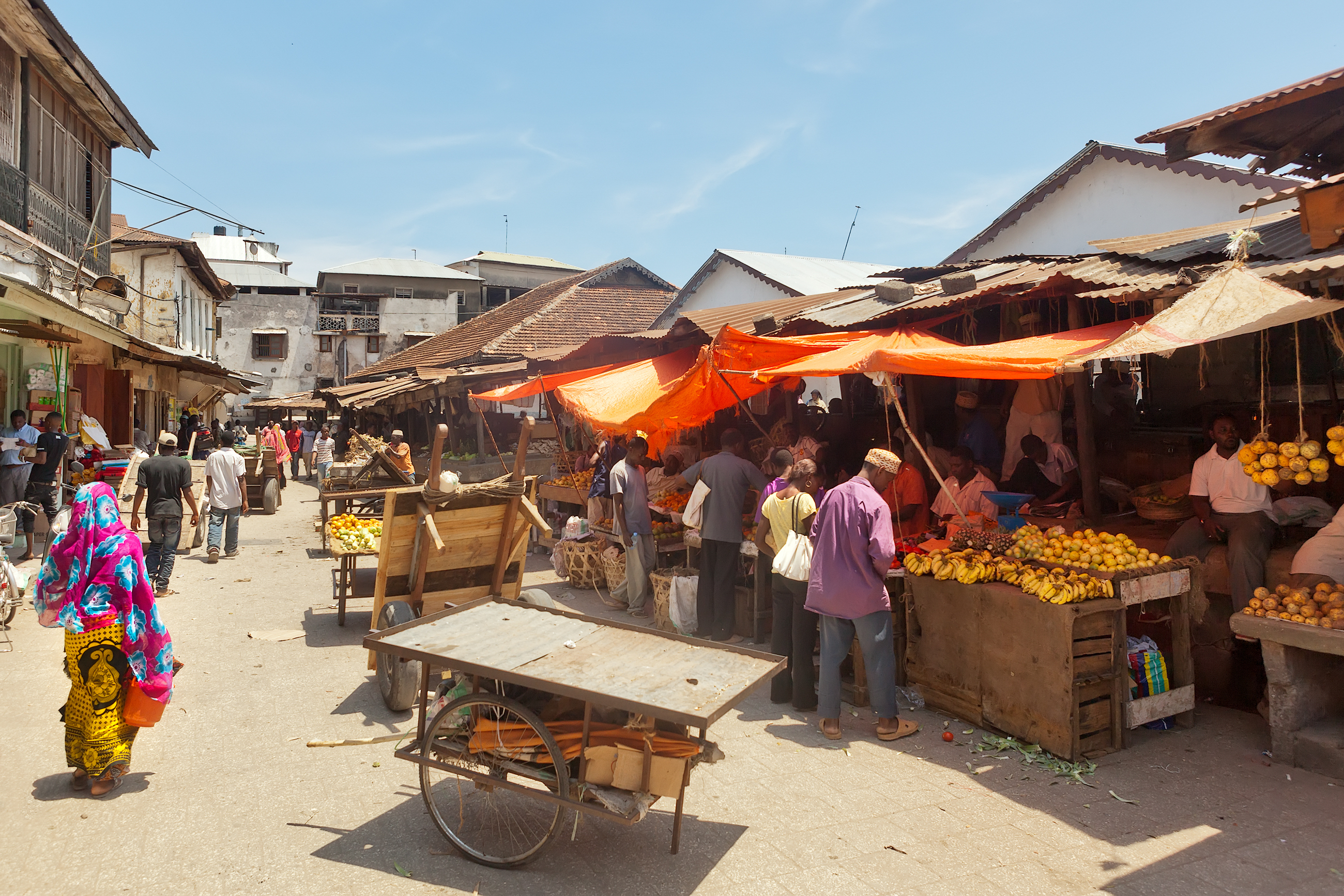 shutterstock_162565484 STONE TOWN, ZANZIBARTANZANIA - APRIL 4 City market under bright sun with sellers and buyers.jpg