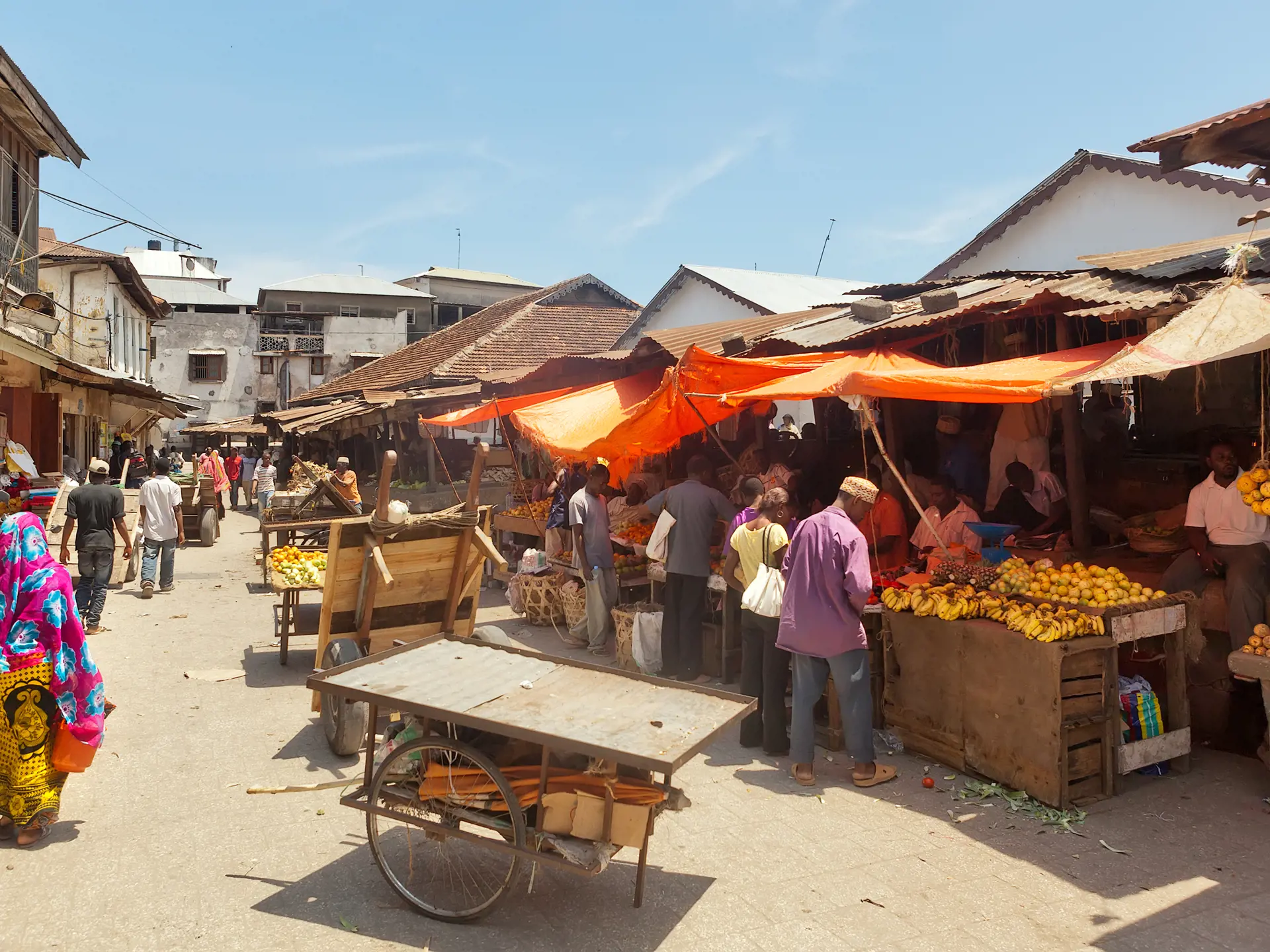 shutterstock_162565484 STONE TOWN, ZANZIBARTANZANIA - APRIL 4 City market under bright sun with sellers and buyers.jpg