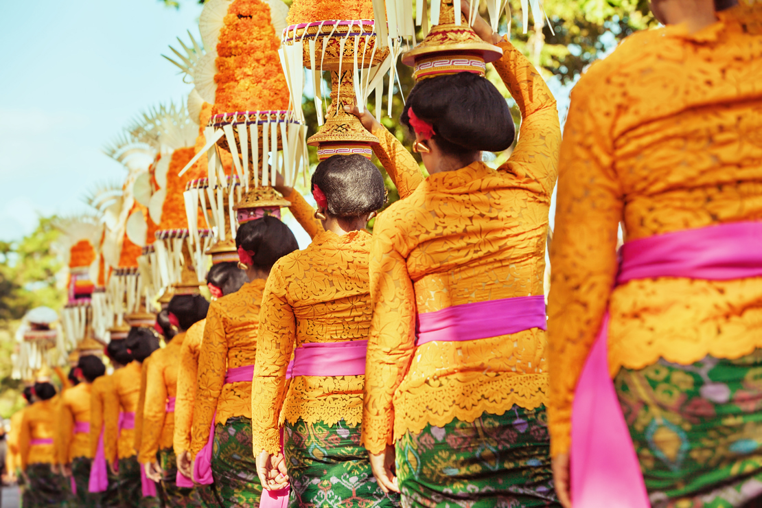 shutterstock_308561210 Procession of beautiful Balinese women in traditional costumes - sarong, carry offering on heads for Hindu ceremony. Arts festival, culture of Bali island and Indonesia people, Asian.jpg