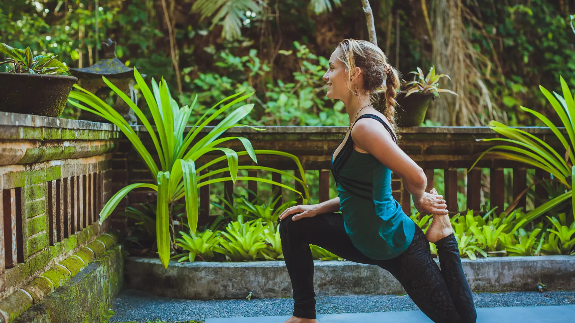 shutterstock_387025426 young woman doing yoga outside in natural environment.jpg
