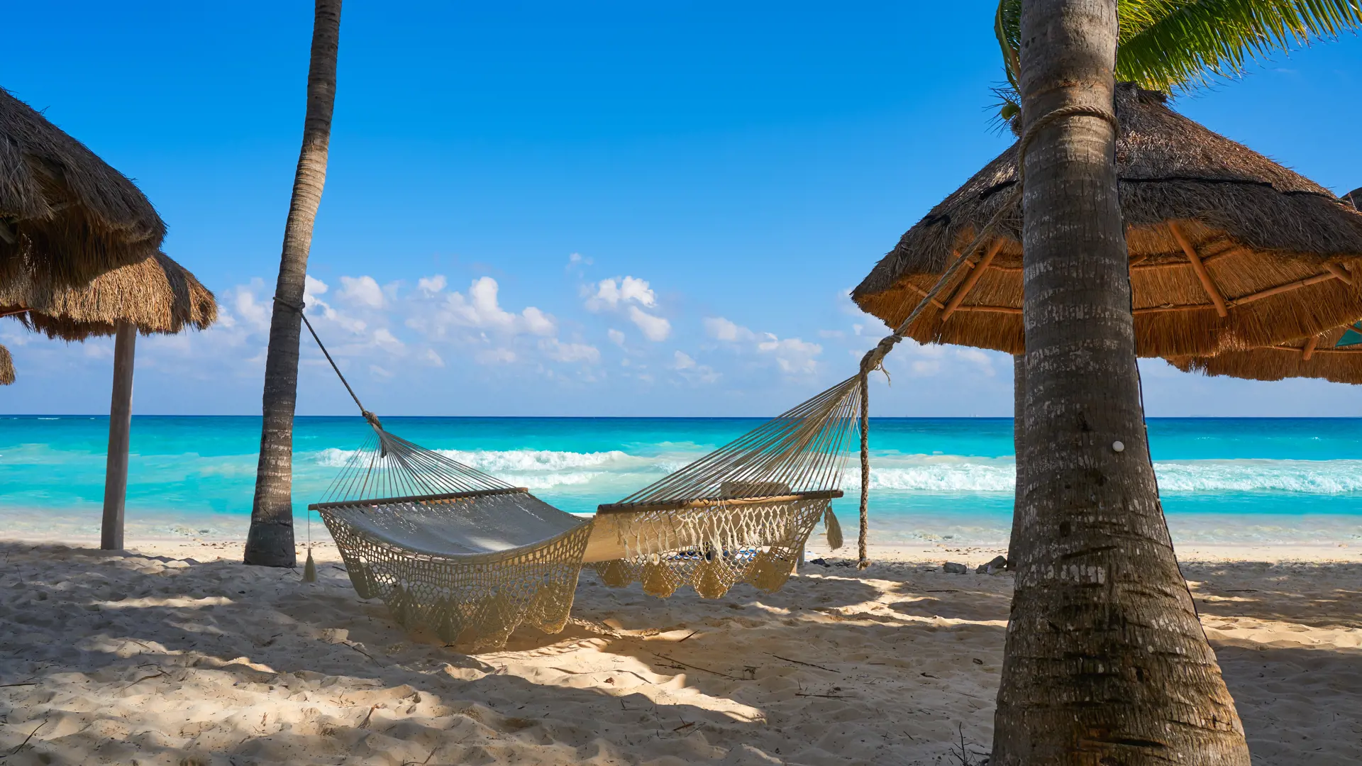 shutterstock_740944774 Playa del Carmen beach hammocks in Riviera Maya Caribbean at Mayan Mexico.jpg