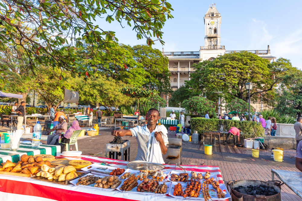 Man Smiling Serving Street Food In Forodhani Park