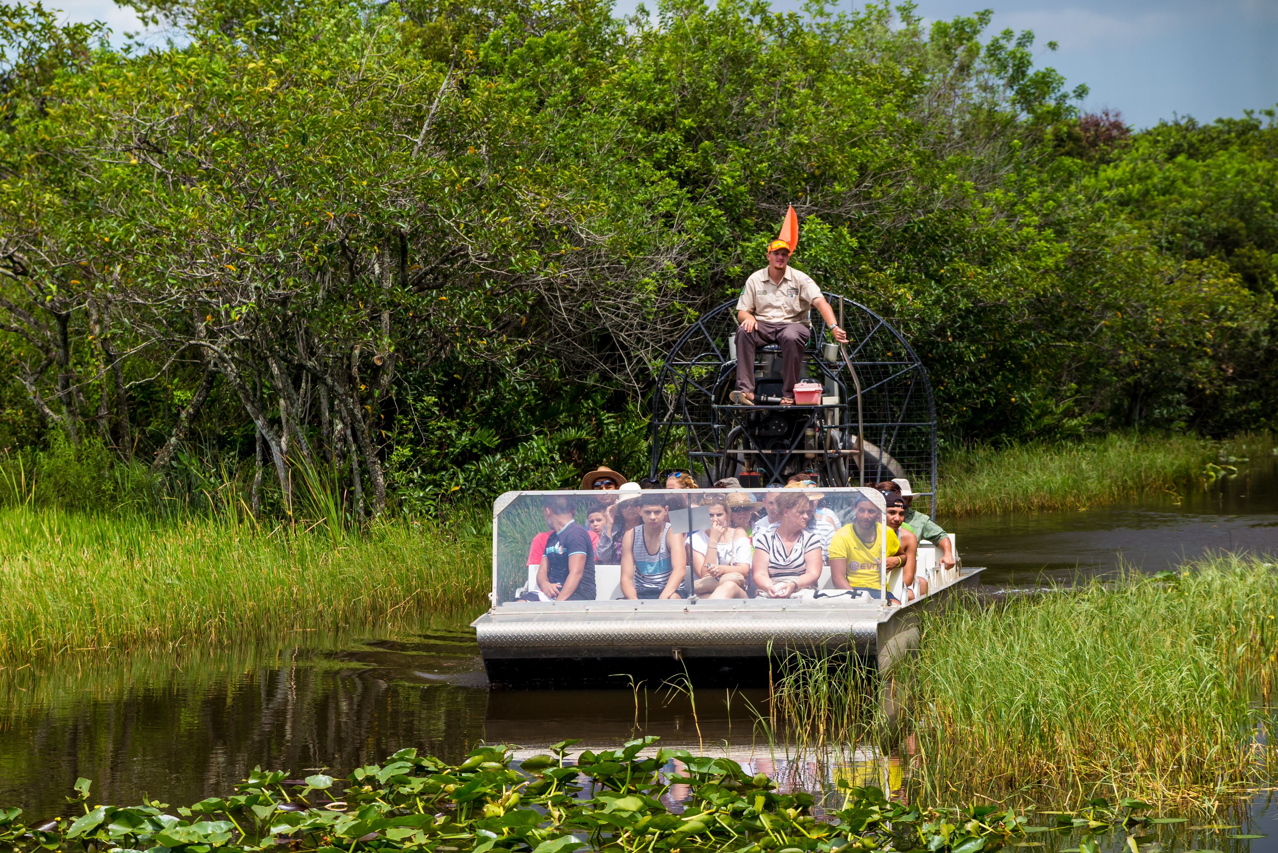 shutterstock_210652315 EVERGLADES, UNITED STATES - August 10, 2014 group of tourists riding an airboat..jpg