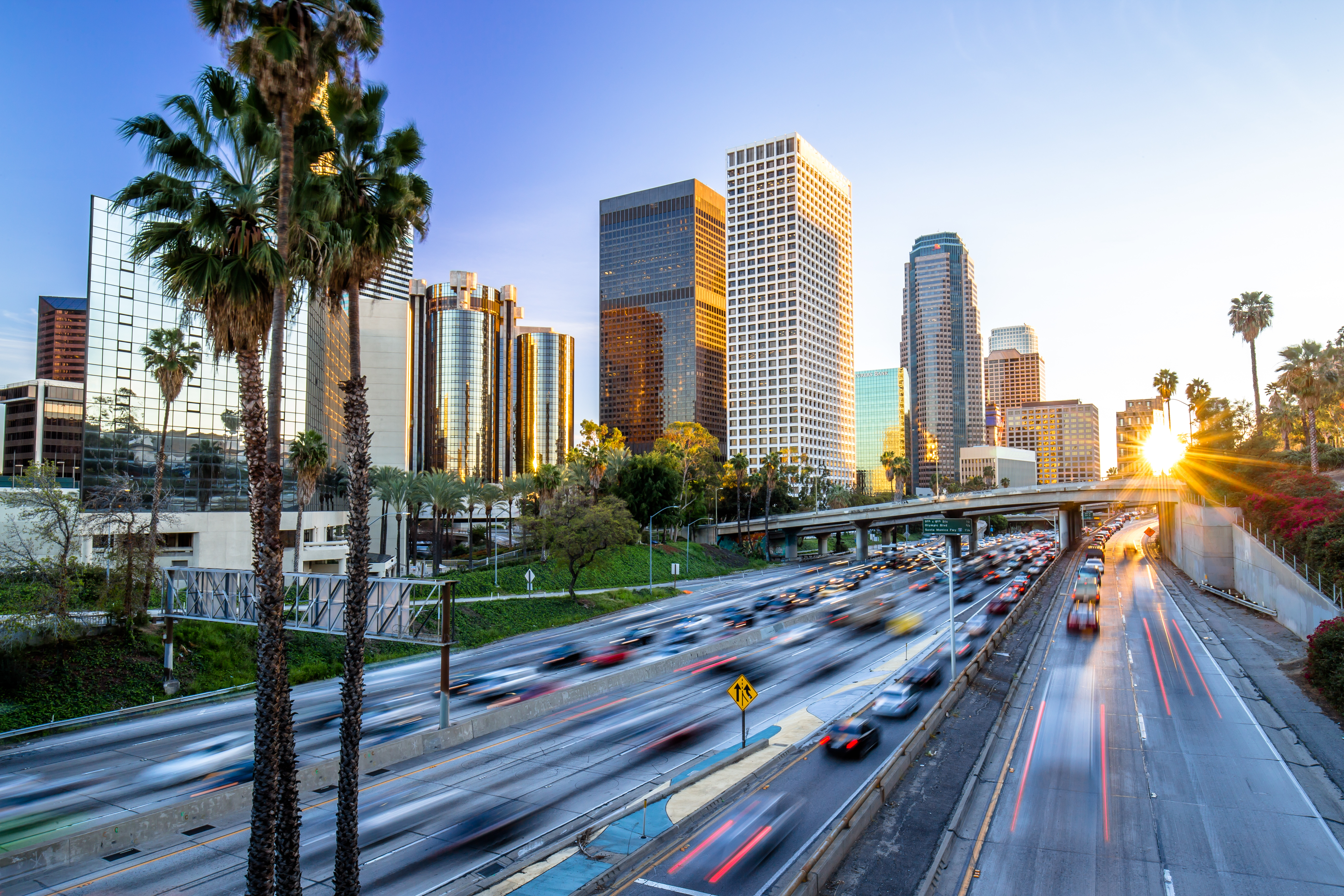 shutterstock_257565412 Los Angeles evening sunset highway traffic skyline buildings.jpg