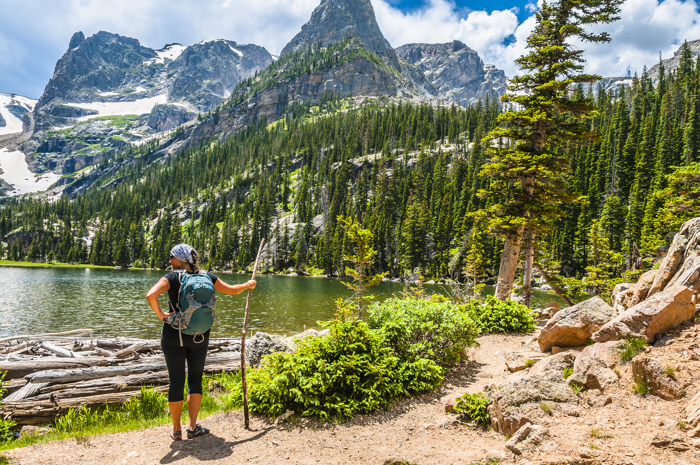 shutterstock_208574044 female enjoying stunning view at lake Odessa with notchtop peak in rocky mountain NP.jpg