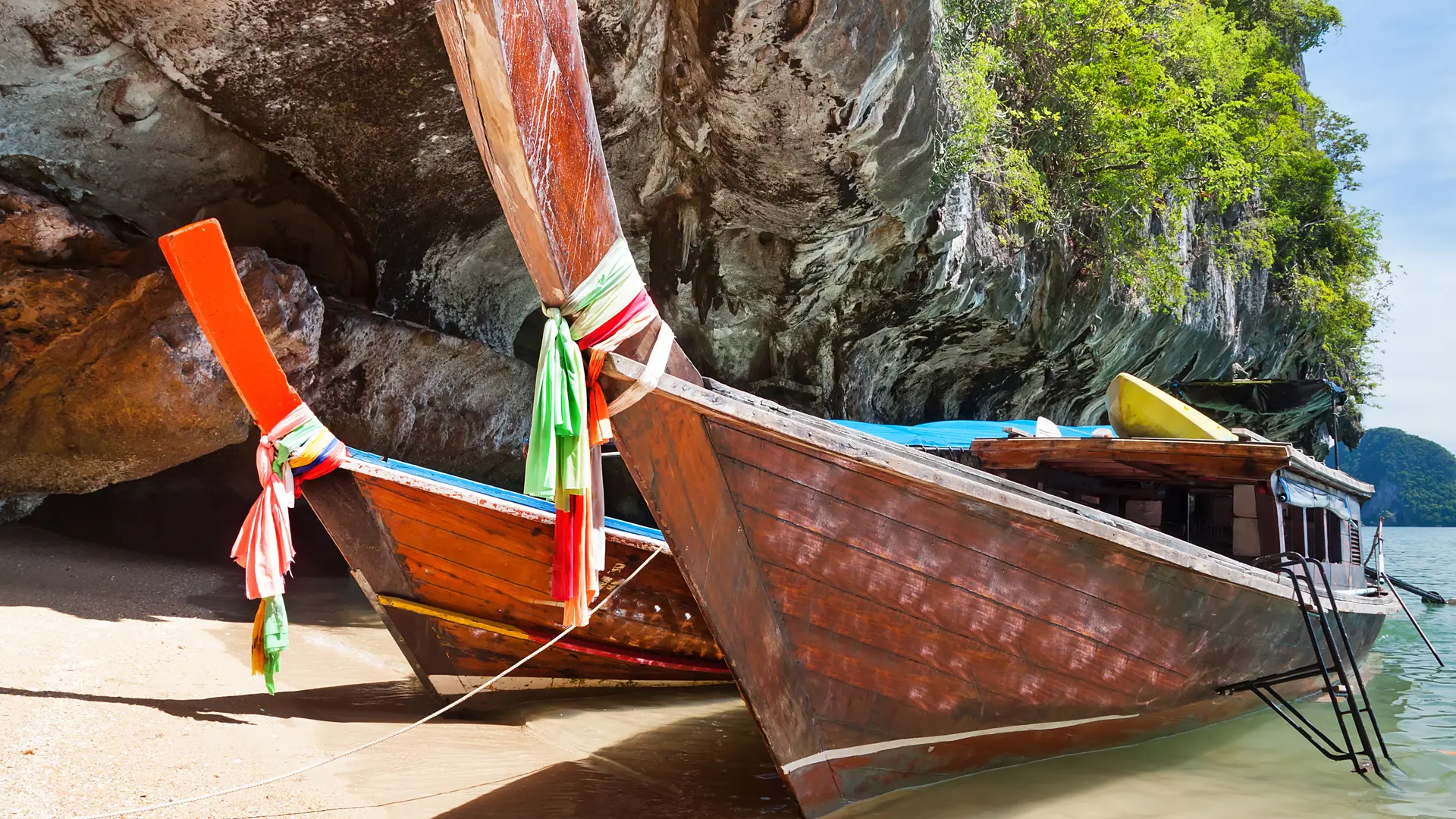 shutterstock_126168743 Thai long tail boats on the coast of Phang Nga Bay.jpg