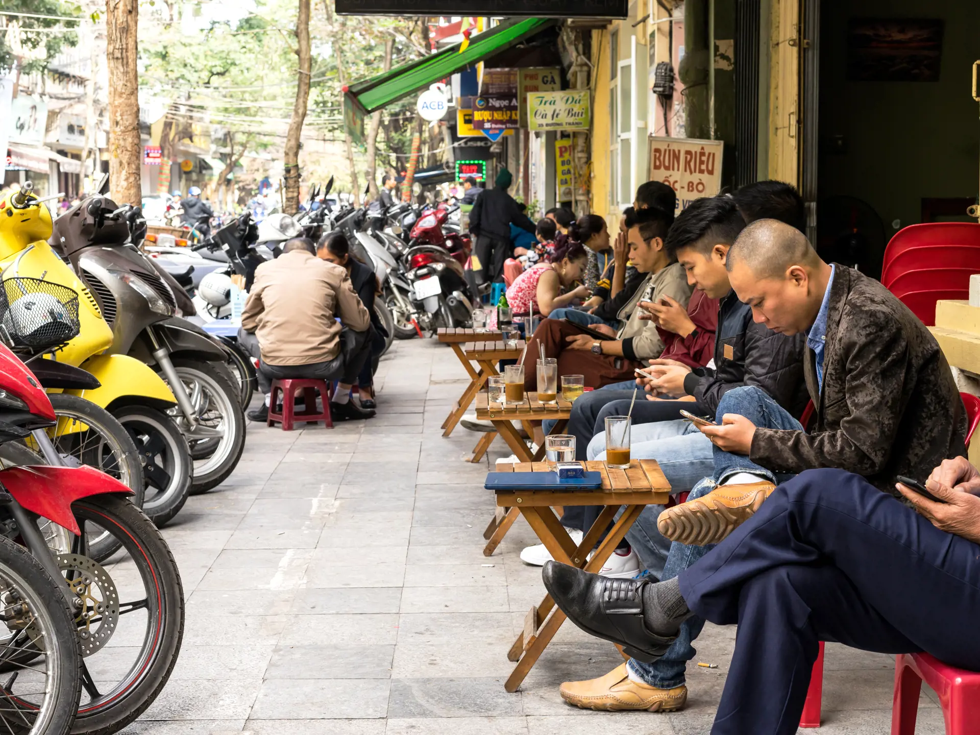 shutterstock_588997853 Hanoi, Vietnam - February 17, 2016 People drink coffee on street at old quarter in Hanoi, Vietnam.jpg