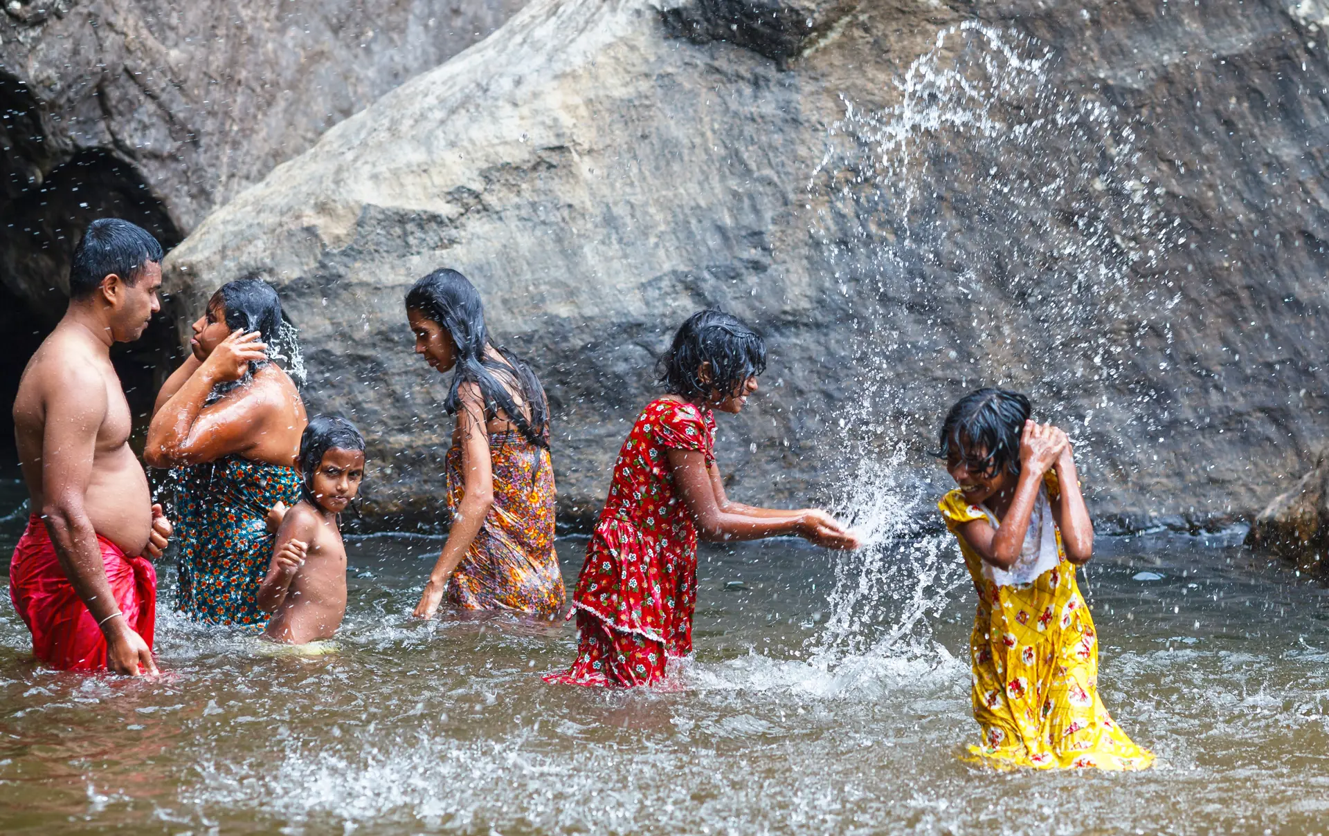 shutterstock_505768432 BAMBARAKANDA WATERFALL, SRI LANKA, MARCH 13 2016 local family bathes in a waterfall..jpg