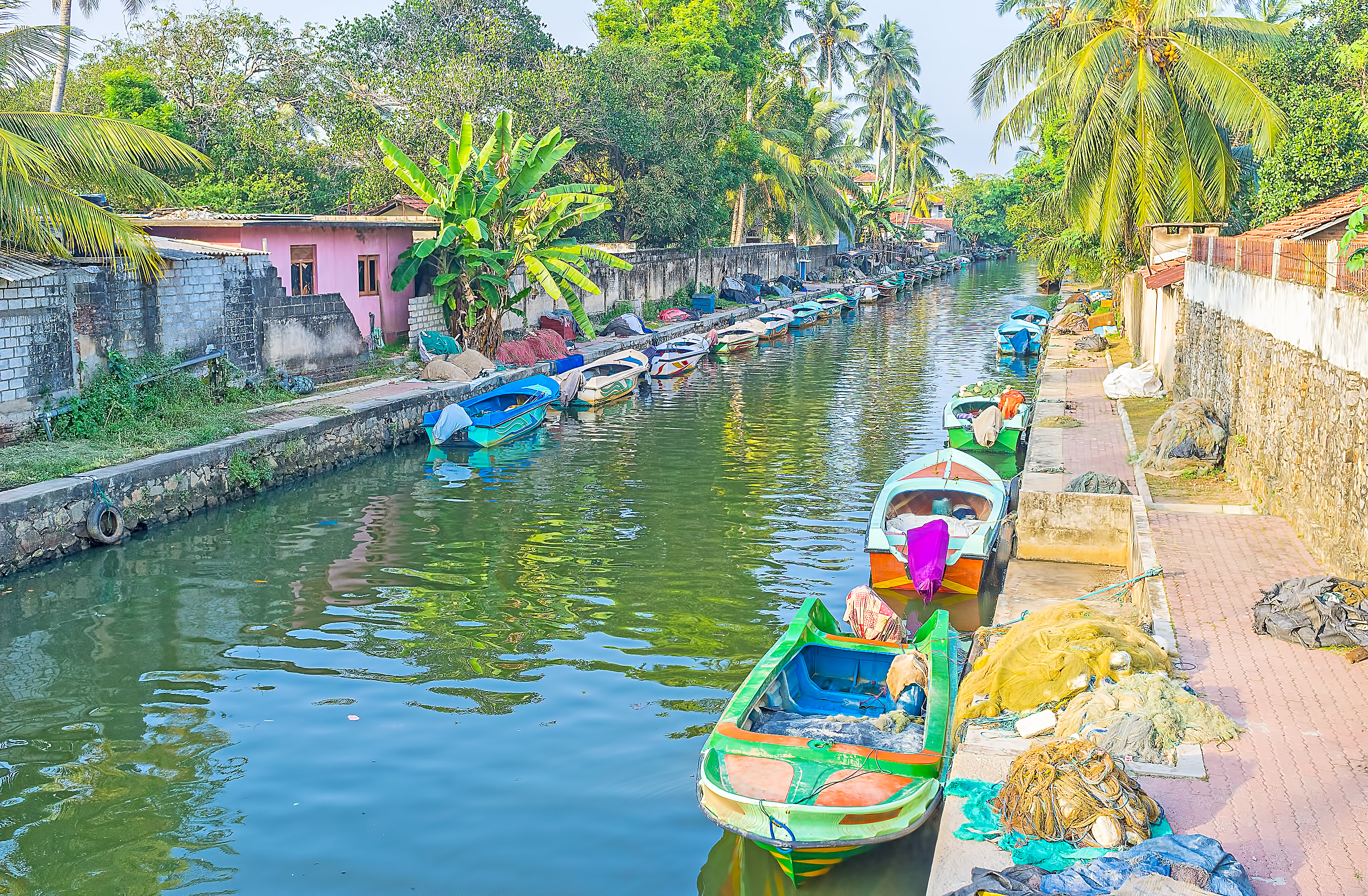 shutterstock_692840440 The colorful boats are docked along the banks of Hamilton's Canal in fishing village district of Negombo, Sri Lanka.jpg (1)