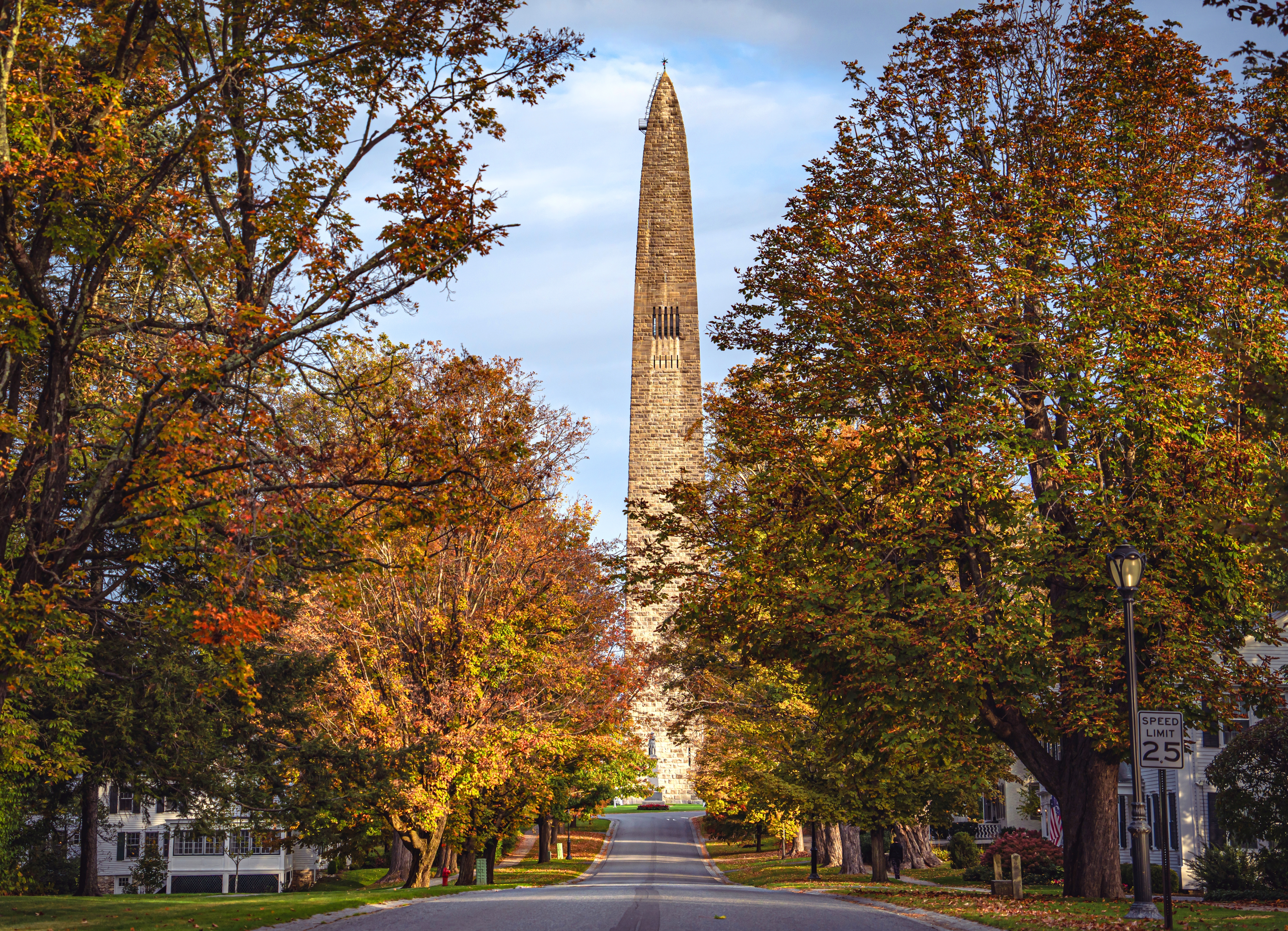 Shutterstock 2401879517 Bennington Battle Monument Looking North On A Clear Autumn Day With Fall Foliage Draping Over The Street.