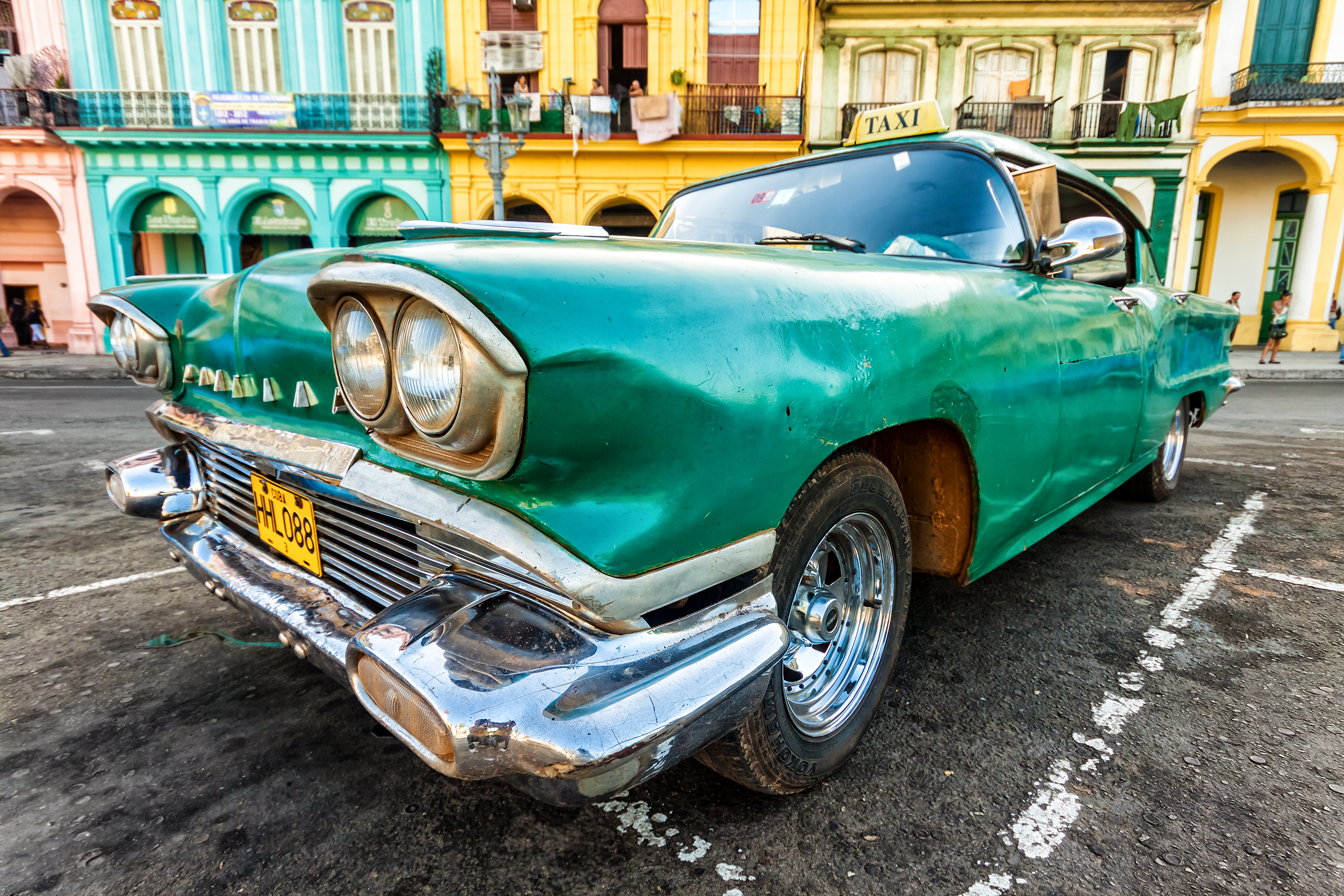 Shutterstock 110700959 Vintage Cadillac In A Colorful Neighborhood August 14,2012 In Havana