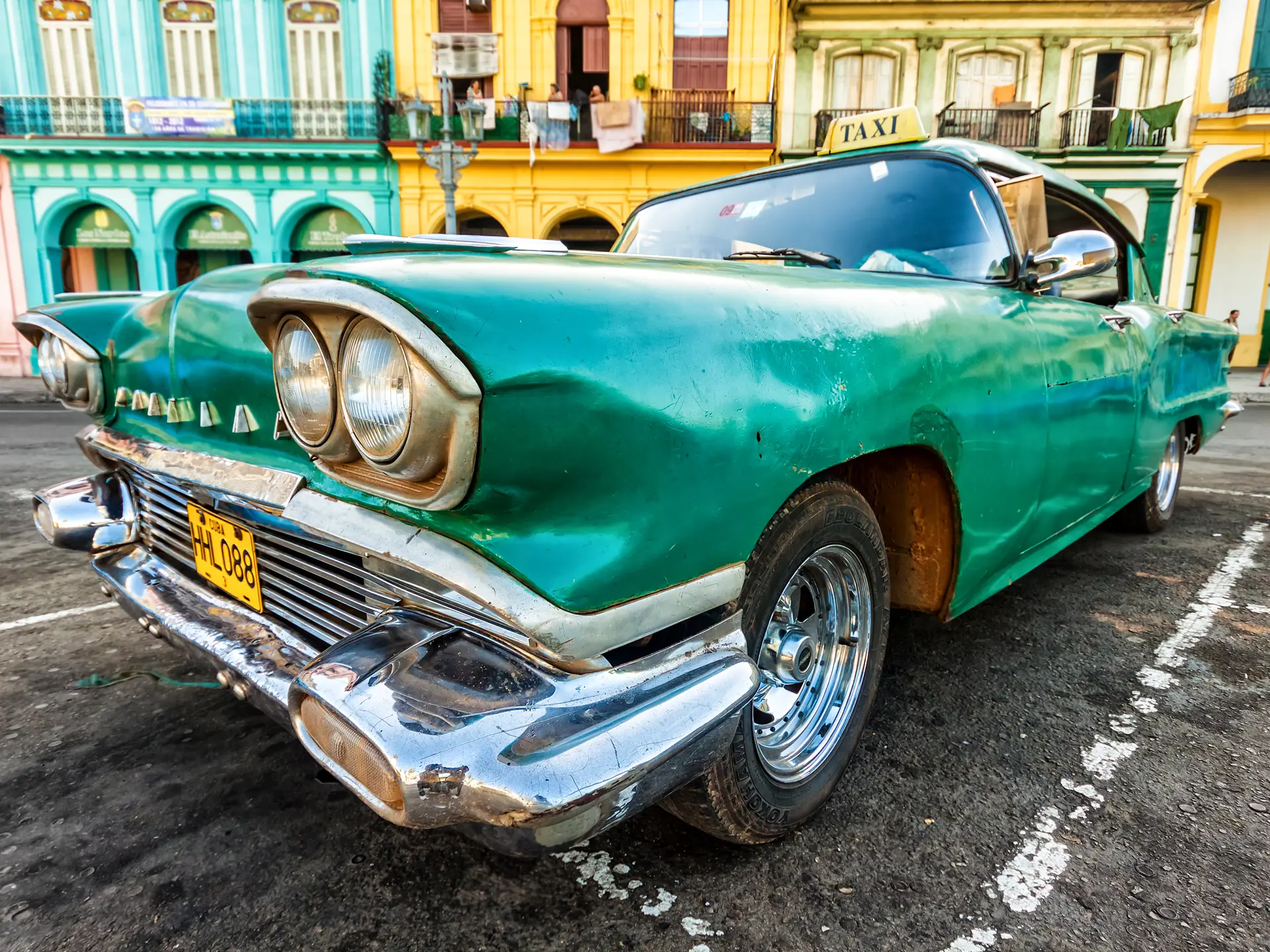 Shutterstock 110700959 Vintage Cadillac In A Colorful Neighborhood August 14,2012 In Havana